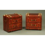 A pair of leather bedside cabinets modelled as trunks, brass bound and studded,