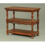 A late 19th century carved walnut three tier book table/buffet,