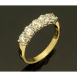 An 18 ct two tone gold diamond set half eternity ring, total diamond weight +/- 1.1 carats.