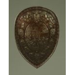 A bronzed metal shield, late 19th century, embossed with antiquarian battle scene to the centre,