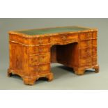 A late 19th century walnut veneered desk, of serpentine form,