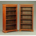 A pair of Edwardian walnut open bookcases,