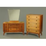 A mid 20th century teak chest of drawers, with matching dressing table,