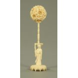 A Chinese carved ivory puzzle ball, late 19th century, the outer skin carved with dragons,