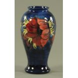 A Moorcroft "Anemone" pattern vase, circa 1980's, the inverted baluster body with dark blue ground,