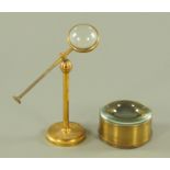 A Victorian gilt brass magnifier on stand, height 25 cm and a similar lens, diameter 11 cm.