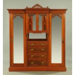 A large late Victorian walnut wardrobe, with detachable moulded cornice above a series of cupboards,