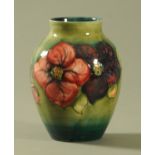 A Walter Moorcroft "Anemone" vase, having a shaded green ground,