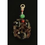 A Chinese carved red amber pendant, longevity peaches with jade ball to the suspension. 4 cm x 3.