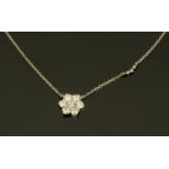 An 18 ct white gold diamond set cluster pendant on chain, total diamond weight +/- .74 carats.