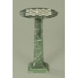 A modern marble games table, the circular top upon an inverted tapering square pedestal,