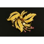 A Continental 18 ct gold floral spray brooch, set with five small rubies, 9.1 grams.