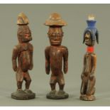 Three African tribal art carved wood figures, mid to late 20th century, 28 cm-29 cm high.