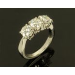 A platinum set three stone diamond ring, round cut and claw set, +/- 2 carats,