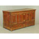 A Georgian oak mule chest, with three panelled top and four panelled front,