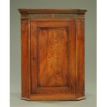 A George III oak hanging corner cupboard,