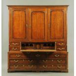 A good North Counties oak and mahogany crossbanded secretaire cupboard,