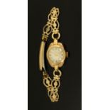 An early 20th century ladies 9 ct gold cased wristwatch, on rolled gold bracelet strap.