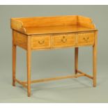 A late Victorian mahogany dressing table, with rear upstand and fitted with three crossbanded,