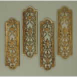 A set of four Edwardian patinated brass finger plates,