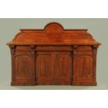 A large Victorian mahogany sideboard, with rear arched upstand,