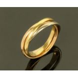 A three colour gold interlocking ring, size O, 5.7 grams.