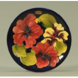 A Walter Moorcroft "Hibiscus" pattern plate, mid 20th century,