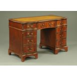 A mahogany pedestal desk, of serpentine outline,