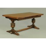 An early 20th century dark oak draw leaf refectory table,