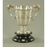 A silver two handled trophy, from the collection of champion trophies awarded to Hexham Clarke,