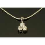 An 18 ct white gold diamond set trefoil pendant on chain, total diamond weight +/- .
