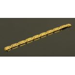 A Continental gold link bracelet, each link in the form of a key fret, the lock stamped "750", 27.
