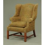 A George III style wing armchair,