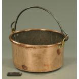 A large 19th century copper circular pot, with bale handle and brass lugs with folded rim,