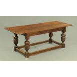 An oak refectory table, with rectangular top, moulded frieze,