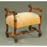 A walnut framed stool, with scroll carrying handles, legs and stretchers, with upholstered seat.