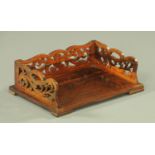 A 19th century rosewood book trough, with fretwork galleried sides and raised on short bracket feet.