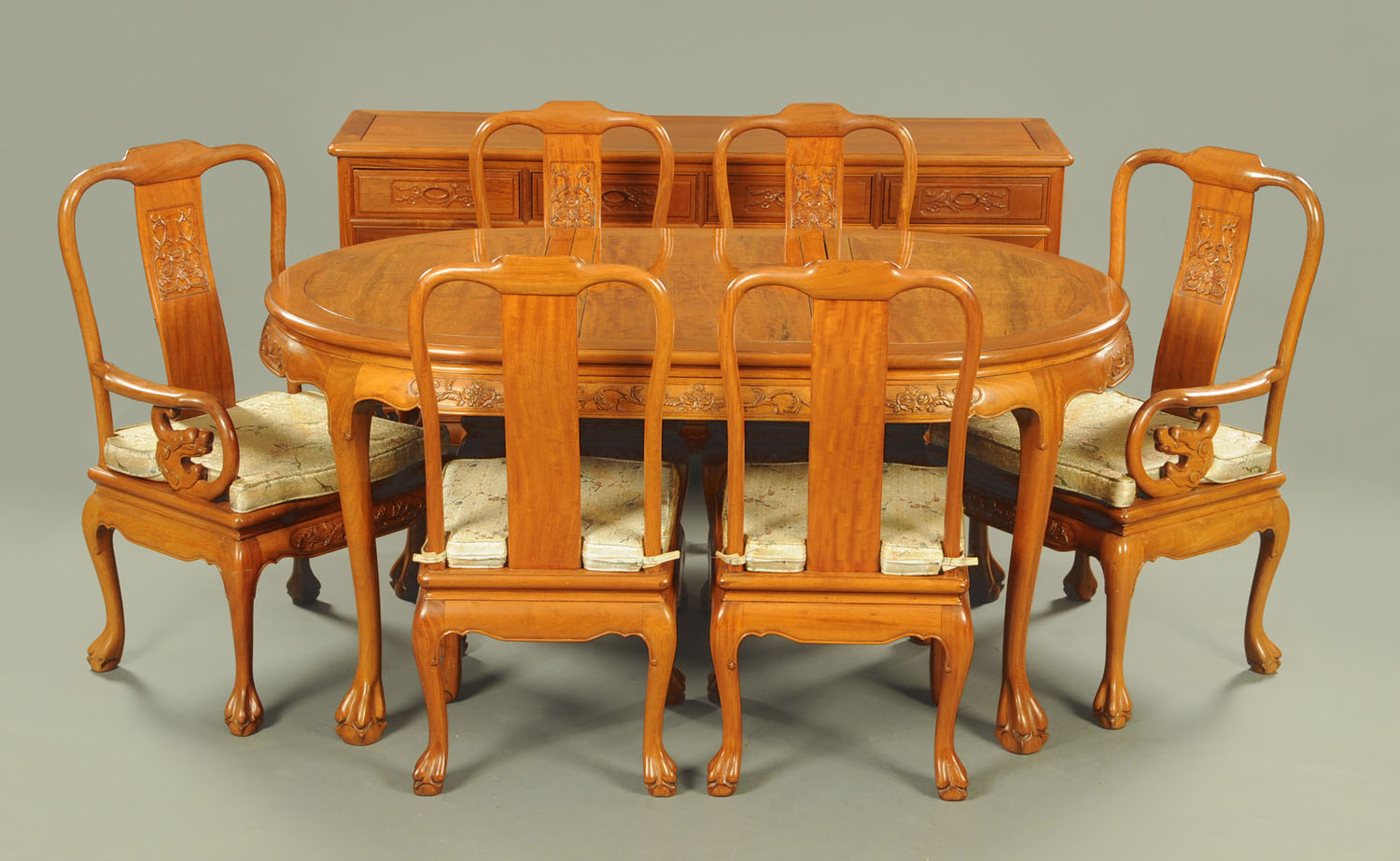 A Chinese rosewood dining room suite, each piece decorated with relief carved flowers,