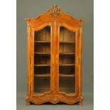 A French carved walnut armoire, late 19th century,