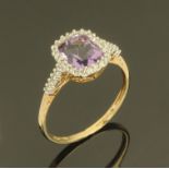 A ladies 9 ct gold dress ring, set with central amethyst framed by small diamonds, ring size V.