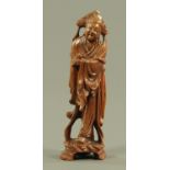 A carved wood figure of a deity, early 20th century. 24 cm high.