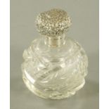 A silver topped scent bottle, repousse with foliate scrollwork, Birmingham 1904, makers mark rubbed.