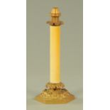 A Victorian candle lamp, with sprung interior, having a plain glass column with foliate capital,