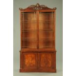 A William IV mahogany bookcase on cupboard,