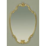 A brass framed mirror. 64 cm x 94 cm.