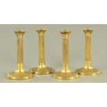 A set of four 19th century gilt copper candlesticks, with removable oval sconces with thread rims,