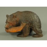 A Japanese carved wood figure of a bear, with salmon in its mouth, late 19th/early 20th century,