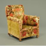 A Howard & Son style Victorian upholstered armchair, with front inverted cup feet on castors.