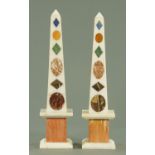 A pair of white marble obelisks,