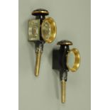 A pair of brass and Japanned black coaching lamps,